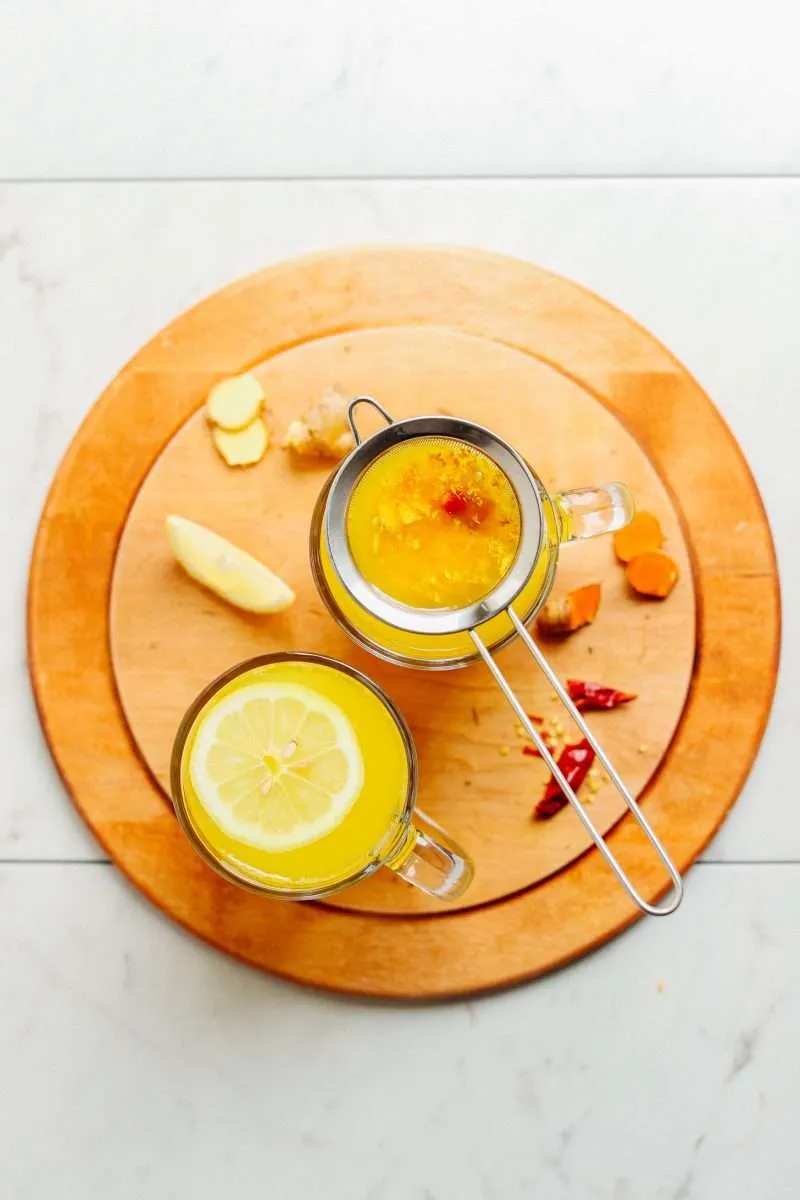 healing turmeric tonic on the wood coster